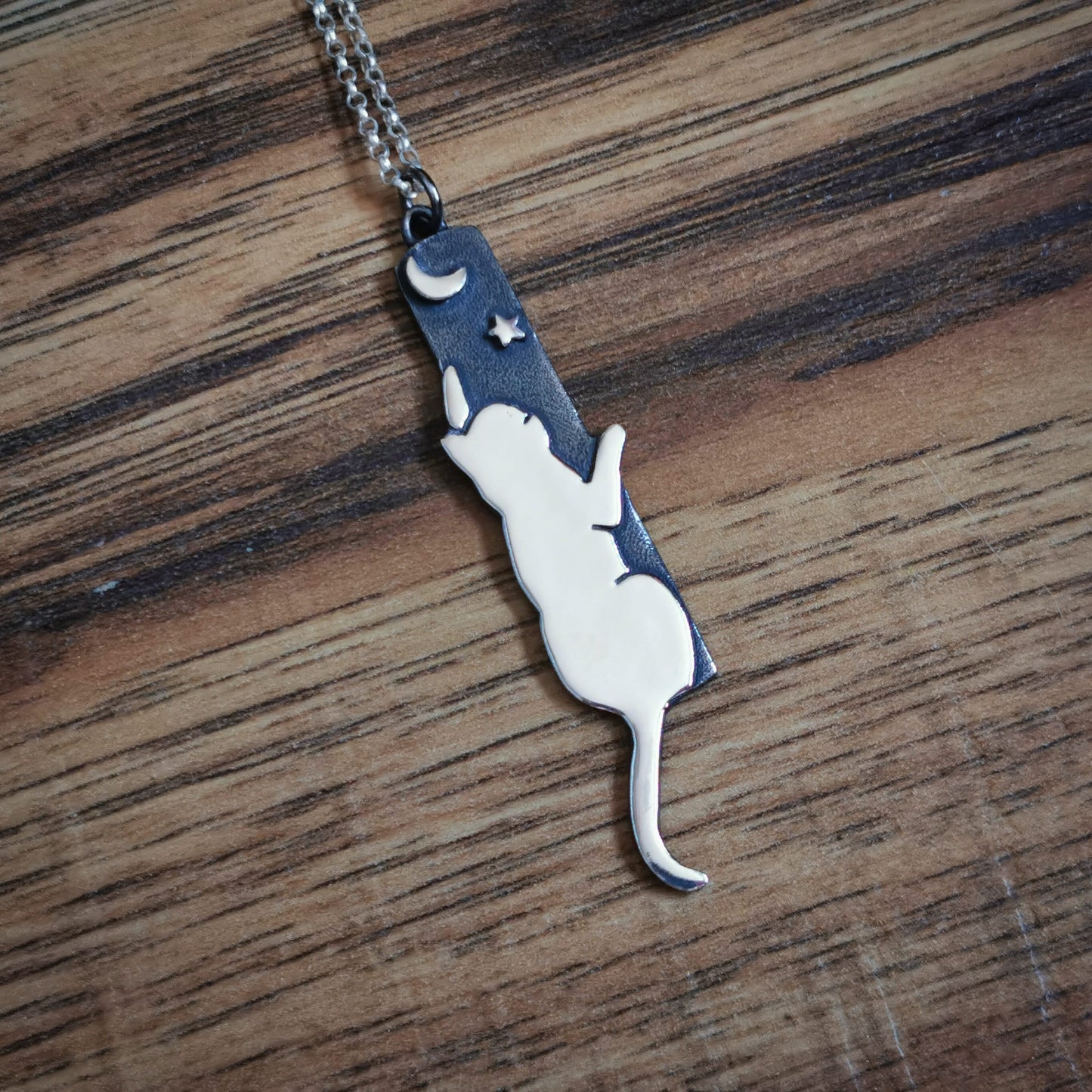 Handmade Sterling silver cat reaching to the moon pendant.