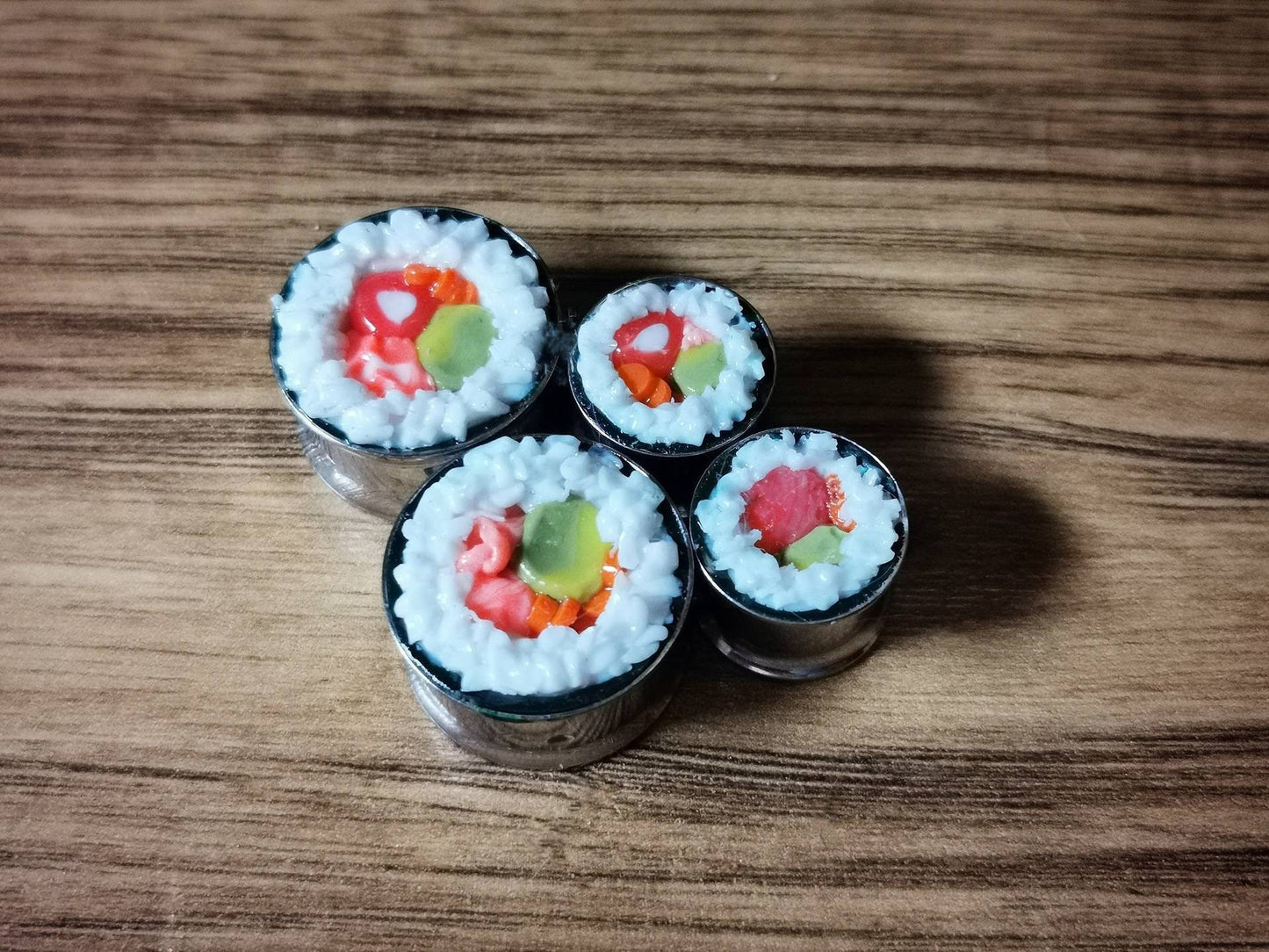 Sushi Plugs Polymer clay in a stainless steel tunnel, miniature food polymer clay plugs.