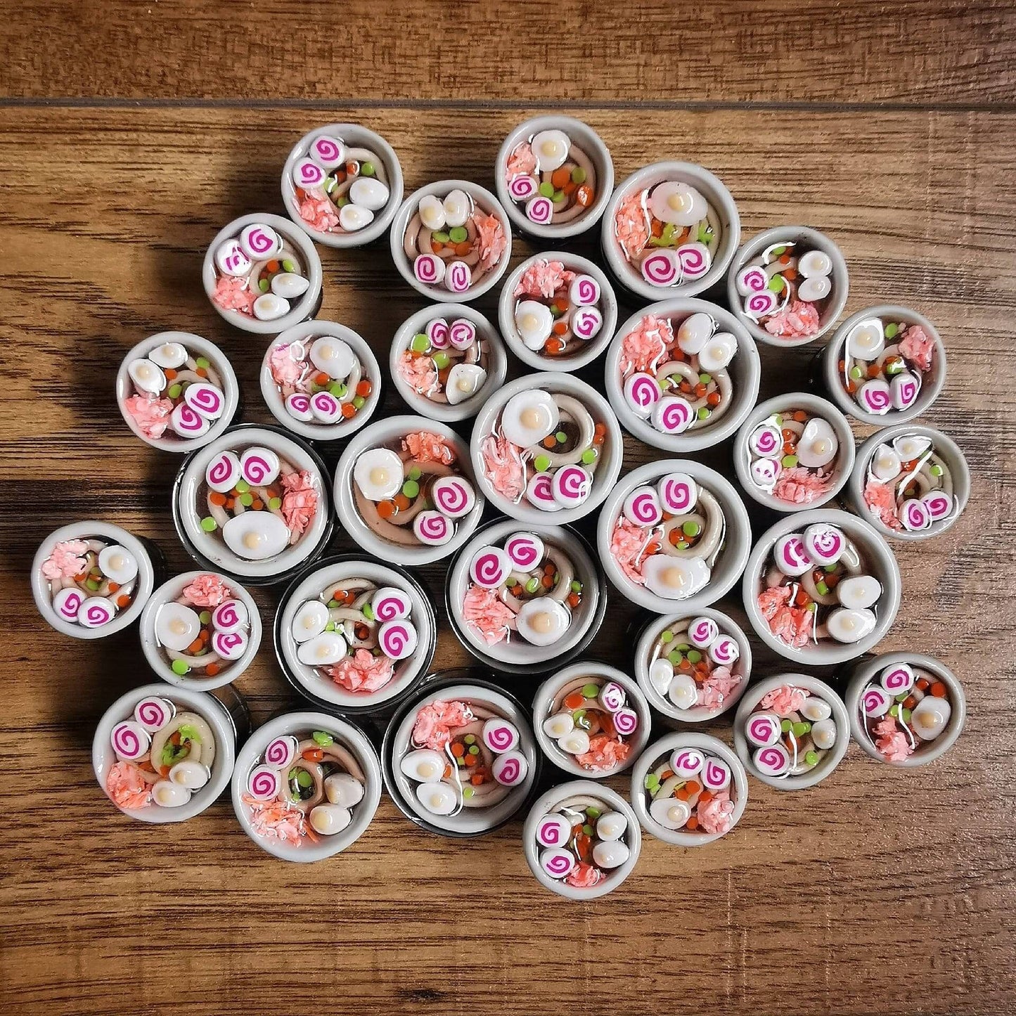 Ramen Plugs Polymer clay in a stainless steel tunnel, miniature food polymer clay plugs.