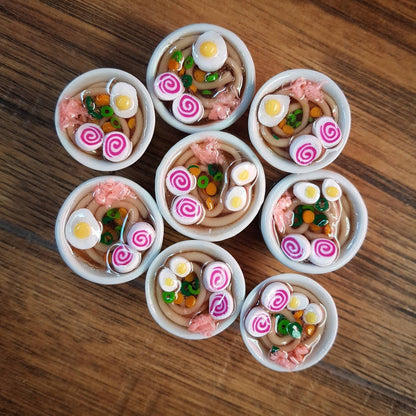 Small bowls filled with a variety of colorful food items on a wooden surface