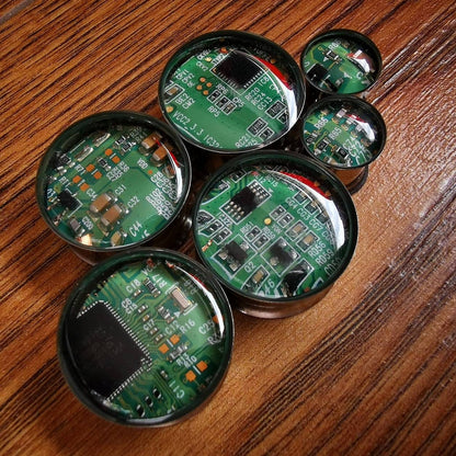 Circuit board plugs, 10mm and above computing recycled board plugs on a wooden backdrop