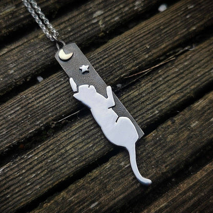 Necklace with a cat pendant on a wooden surface