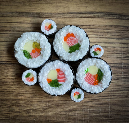 Decorative sushi rolls plug earrings on a wooden surface
